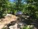 1989 Ford Bronco - A blue SUV navigates a challenging rocky trail with another vehicle in the background.