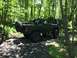 1989 Ford Bronco - Modified 1989 Ford Bronco navigating an off-road trail with another vehicle visible in the background.