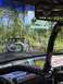 1989 Ford Bronco - Multiple off-road vehicles navigate a wooded trail on a sunny day. The view is from the perspective of one of the vehicles.