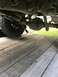 1989 Ford Bronco - A close-up view of the rear axle and suspension components of a vehicle.