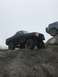 1989 Ford Bronco - Two Ford Broncos navigating a challenging rocky off-road course.