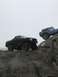 1989 Ford Bronco - Two Broncos navigate a rocky trail on a foggy day.