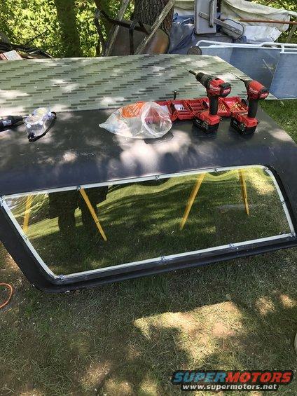 Black hard top with window frame and tools on top