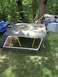 1989 Ford Bronco - Hardtop for a 1989 Ford Bronco sits on yellow sawhorses in a grassy yard.
