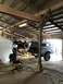 1989 Ford Bronco - Two 1989 Ford Broncos are visible in a garage, with one lifted for service.