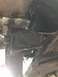 1989 Ford Bronco - Leaf spring shackle bracket, possibly from a 1989 Ford Bronco, showing some wear and tear.