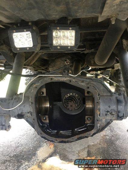Underside of a vehicle showing an open differential housing with two LED light bars mounted above