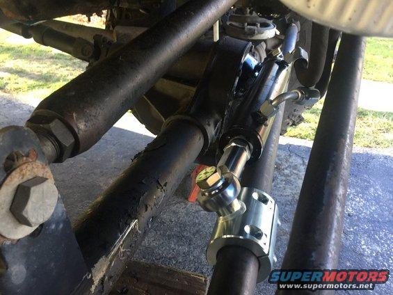 Steering stabilizer shock absorber mounted on vehicle linkage