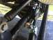 1989 Ford Bronco - Close-up view of a steering stabilizer shock absorber installed on a vehicle's linkage system.