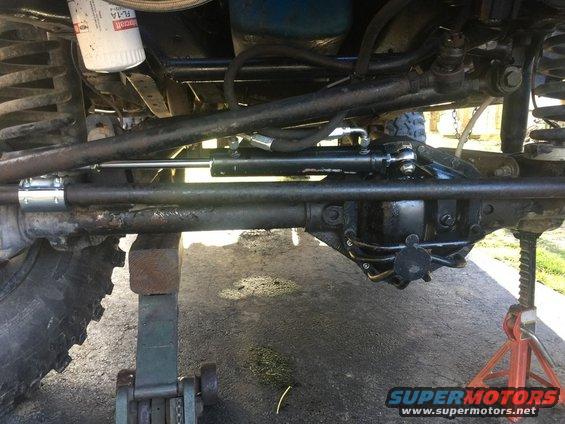 1989 Ford Bronco steering linkage and front axle, supported by jacks