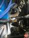 1989 Ford Bronco - Close-up view of engine components, including spark plug wires and exhaust piping.