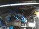 1989 Ford Bronco - Close-up view of an engine bay, highlighting custom snorkel installation with blue tubing.