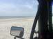 1989 Ford Bronco - Looking out at the ocean and sandy beach from the perspective of someone inside a vehicle.