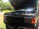 1989 Ford Bronco - Front view of a 1989 Ford Bronco, hood up, revealing the engine bay and grille.
