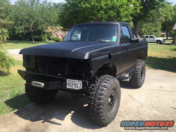 Black lifted pickup truck with aftermarket bumper and winch. License plate reads 403 2L7