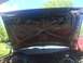 1989 Ford Bronco - The underside of an open hood reveals the engine bay and surrounding components.