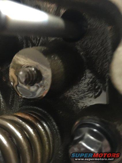 Close-up of engine valve springs and bolts with SuperMotors.net watermark