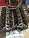 1989 Ford Bronco - Engine block and cylinder heads disassembled, revealing internal mechanical parts.