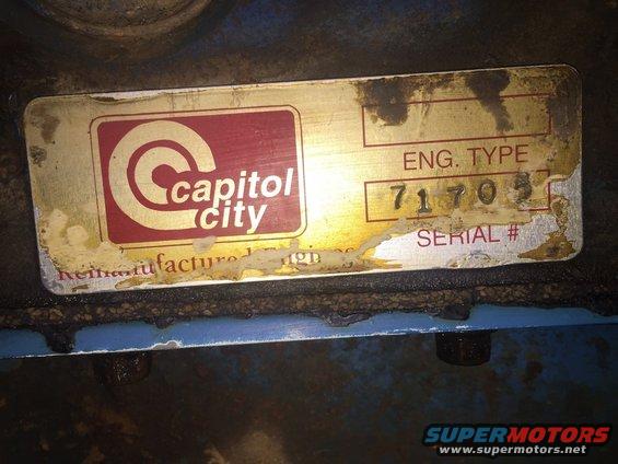 Close-up of a metal plate on an engine, showing 'Capitol City' logo and 'ENG. TYPE 71705 SERIAL #'