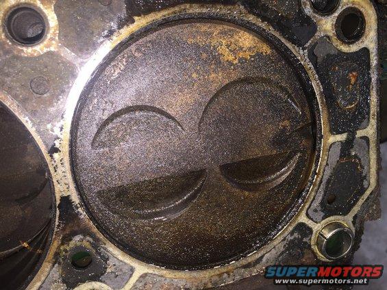 Engine cylinder showing piston top with two valve reliefs