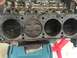 1989 Ford Bronco - Close-up view of an engine block's cylinders and pistons, indicating internal engine components.