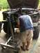 1989 Ford Bronco - Engine hoist is positioned over a vehicle's engine bay as a man works on it.