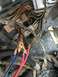 1989 Ford Bronco - A close-up view of a vehicle's complex wiring harness shows frayed wires and exposed copper.