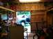 1989 Ford Bronco - A blue SUV is parked inside a cluttered garage with its doors open.