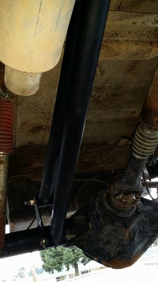 Close-up of a black metal roll cage tube with mounting hardware