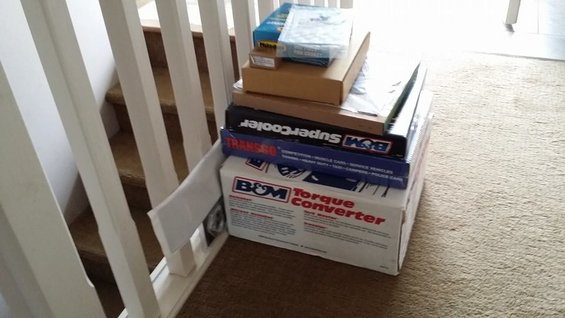 Stack of B&M automotive parts boxes including a Torque Converter and SuperCooler