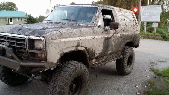 Mud-covered 1980s SUV, 3q-front view