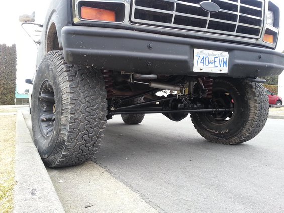Front view of a lifted truck with large tires and a black grille. License plate reads 740 EVW