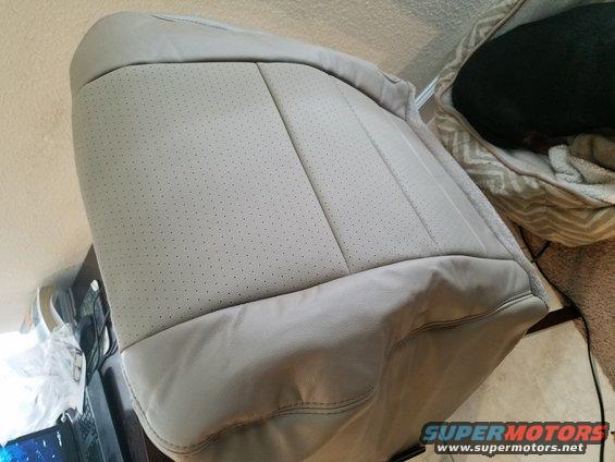 Light gray perforated leather car seat with stitching detail