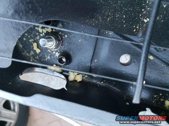 Seat mounting bracket with bolt and foam debris