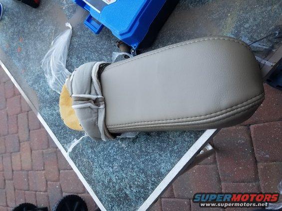 Tan center console armrest with stitching detail