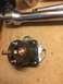 1989 Ford Bronco - Starter solenoid and a ratchet wrench are shown on a wooden surface.