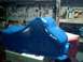 1989 Ford Bronco - A freshly painted blue oil pan sits on a box in a workshop.