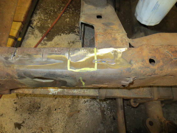 Rusted metal frame section with yellow markings and cutouts