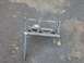 1989 Ford Bronco - A custom metal bracket is shown resting on an asphalt surface.