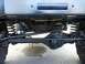 1989 Ford Bronco - Close-up of the front axle and steering system, showing the tie rod and drag link.