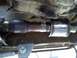 1989 Ford Bronco - Underside view of a vehicle's exhaust system, showing a muffler and pipe connections.