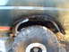 1989 Ford Bronco - This photo shows the wheel well and tire of a vehicle, with visible signs of wear and tear.