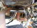 1989 Ford Bronco - Close-up view of the undercarriage, highlighting mechanical parts and suspension system.