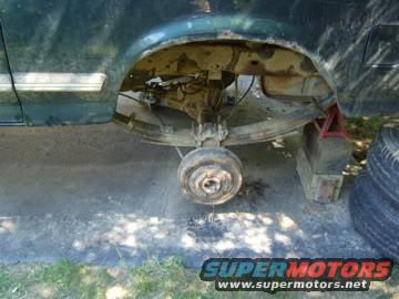 rear axle and suspension of a vehicle, jacked up with a wheel removed