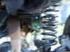 1989 Ford Bronco - Close-up view of a vehicle's suspension spring and associated hardware, with a SuperMotors.net watermark.