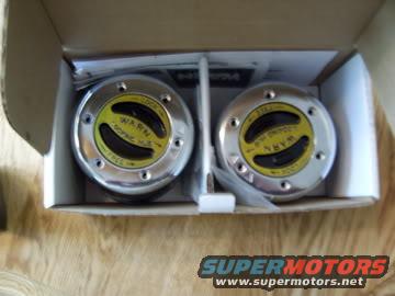 Pair of Warn manual locking hubs in a cardboard box with instructions