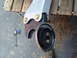 1989 Ford Bronco - Vehicle suspension part shown with hardware and a clamp on the ground.