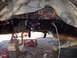 1989 Ford Bronco - Undercarriage view of a vehicle's frame and suspension system, supported by jack stands.