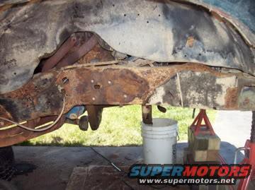 rusted vehicle frame, part view, SuperMotors logo
