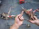 1989 Ford Bronco - Vehicle suspension parts are laid out on a concrete surface, with hands interacting with the components.